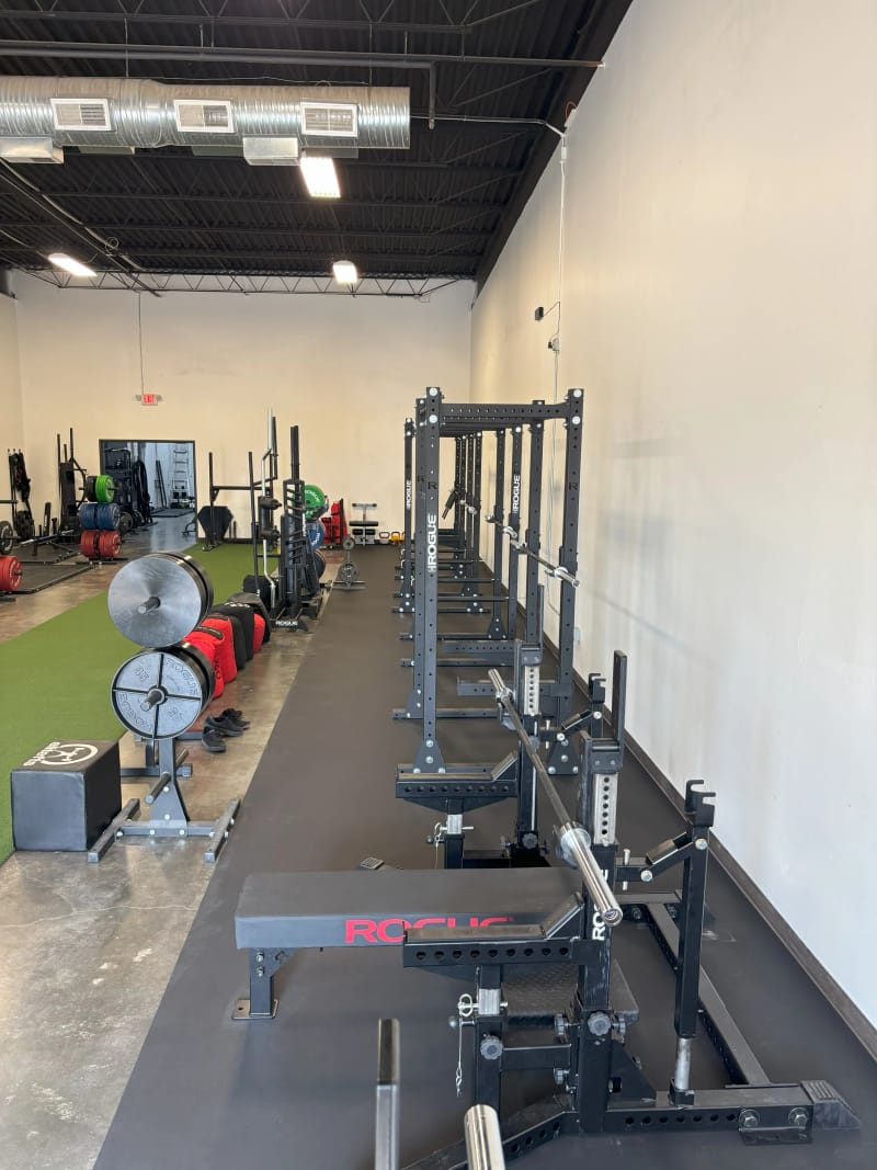 Squat racks and lifting platforms at Per Aspera strength training gym