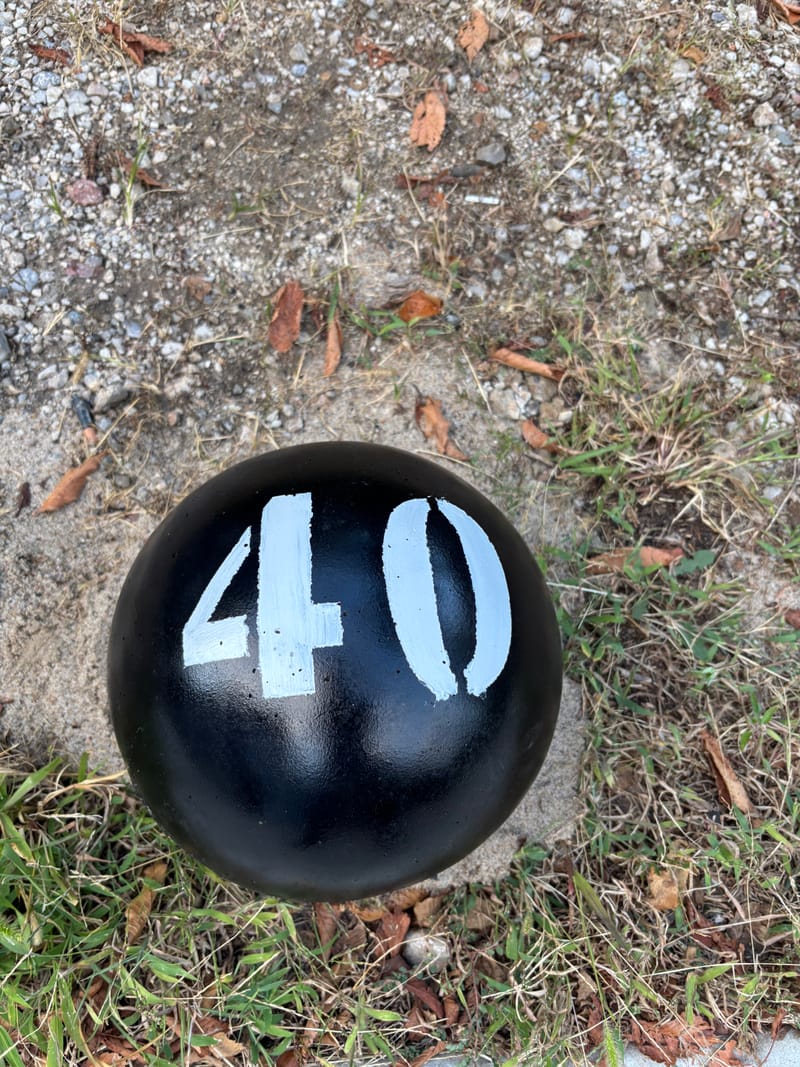 40 lb training atlas stone in a black finish with a stenciled number