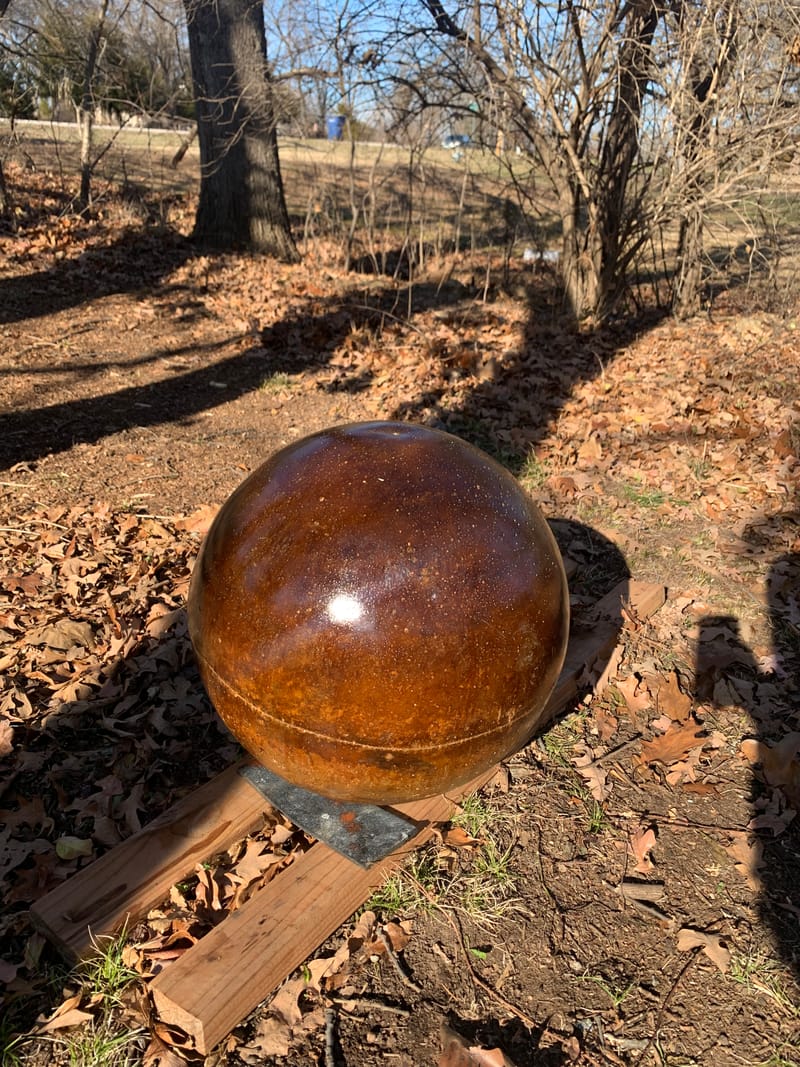 Large amber-brown atlas stone with a darker band, sealed and drying outdoors